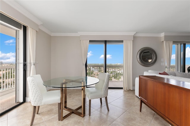 dining area featuring a healthy amount of sunlight, ornamental molding, and light tile patterned floors