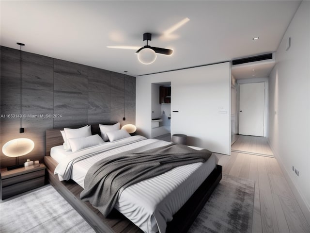 bedroom with ceiling fan, hardwood / wood-style flooring, and tile walls