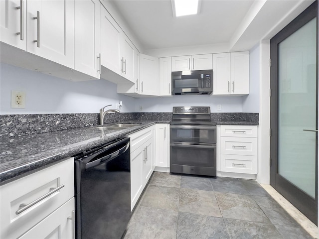 kitchen featuring dark stone countertops, black appliances, white cabinetry, and sink