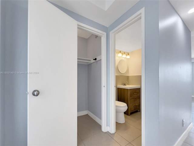 interior space featuring tile patterned flooring, vanity, and toilet