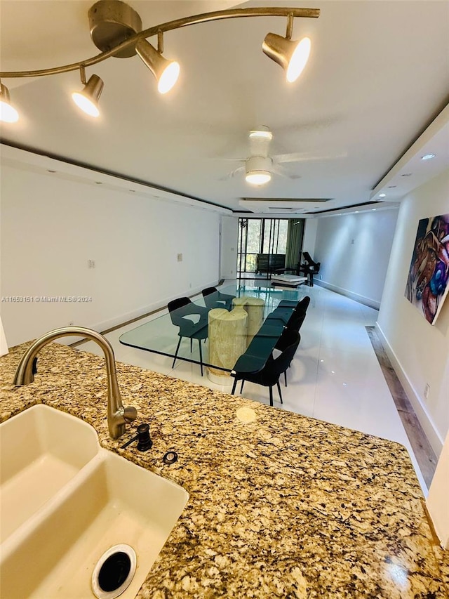 interior space with sink and ceiling fan