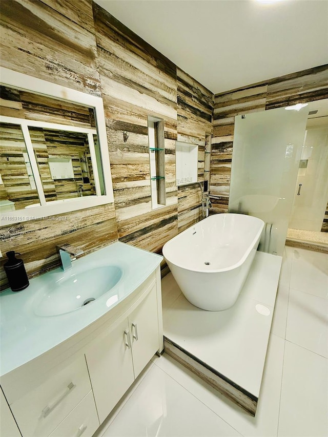 bathroom with vanity, a tub to relax in, wooden walls, and tile patterned floors