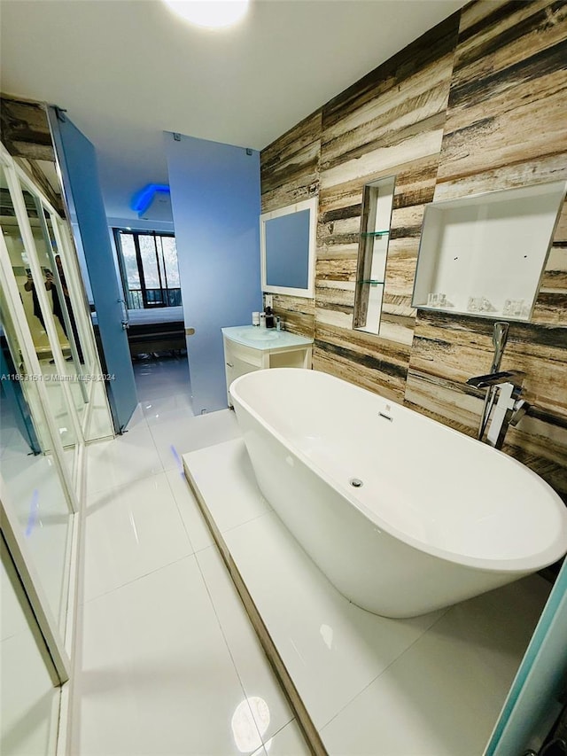 bathroom with wooden walls, tile patterned floors, and a washtub