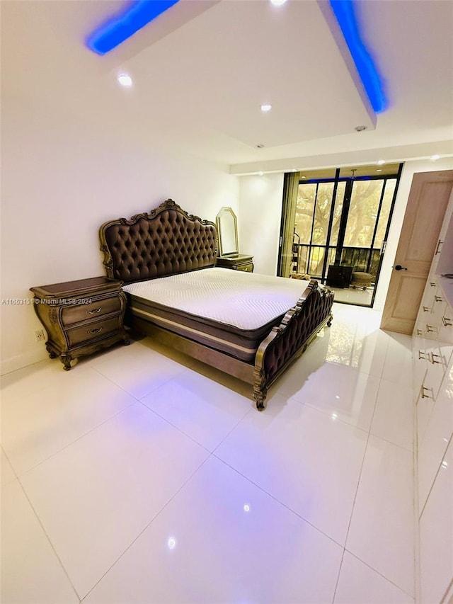 bedroom with light tile patterned flooring and access to exterior