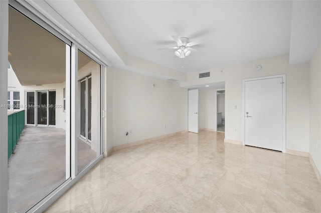 empty room with marble finish floor, baseboards, visible vents, and a ceiling fan