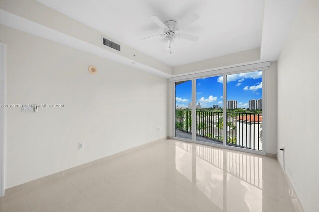 unfurnished room featuring light tile patterned floors and ceiling fan