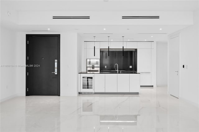 kitchen featuring beverage cooler, white cabinetry, black refrigerator, and electric panel