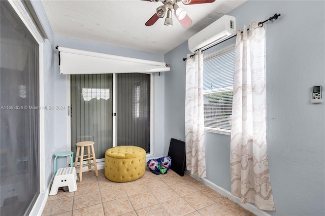 interior space featuring ceiling fan, light tile patterned floors, and a wall mounted air conditioner