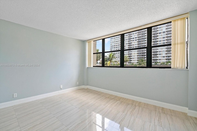 spare room featuring a textured ceiling