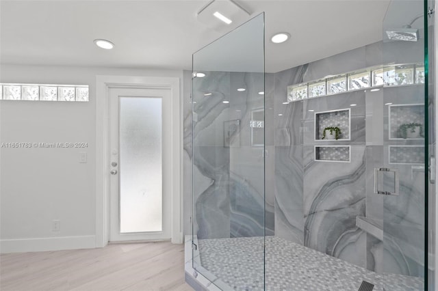 bathroom featuring hardwood / wood-style floors and a shower with shower door