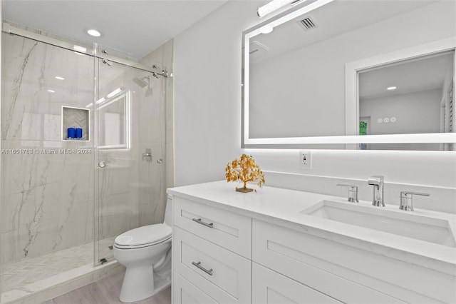 bathroom featuring hardwood / wood-style floors, vanity, and walk in shower