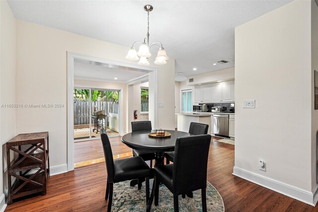 dining room featuring dark wood-type flooring and a chandelier