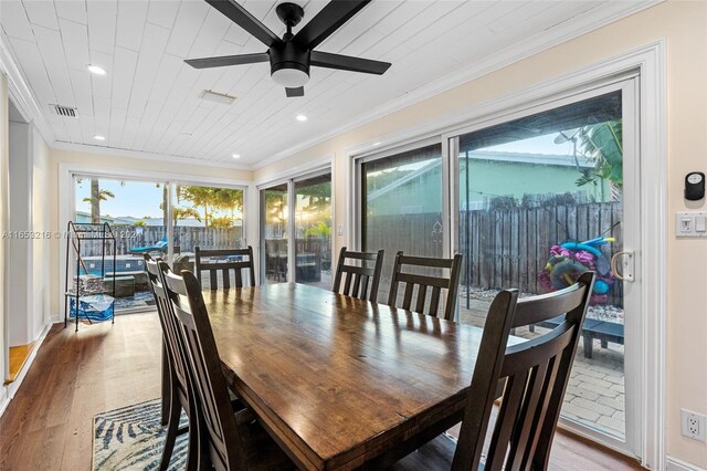 dining area featuring ceiling fan, hardwood / wood-style flooring, and crown molding