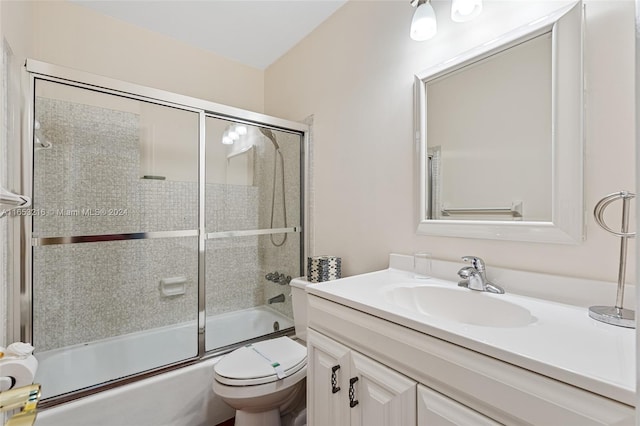 full bathroom with vanity, toilet, and combined bath / shower with glass door