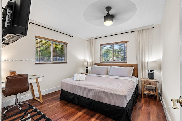 bedroom with dark wood-type flooring and ceiling fan