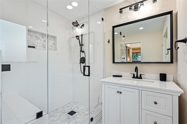 bathroom with vanity and a shower with shower door