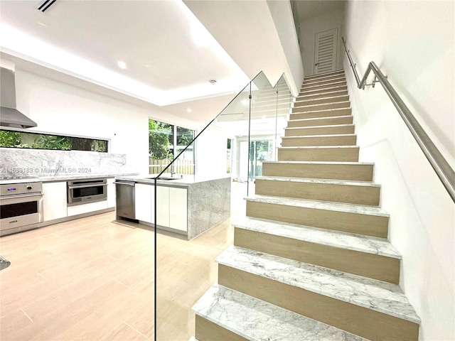 staircase featuring wood-type flooring