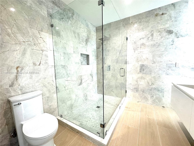 bathroom with walk in shower, tile walls, and toilet