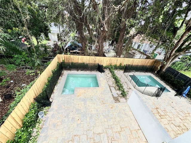 view of swimming pool with a jacuzzi and a patio area