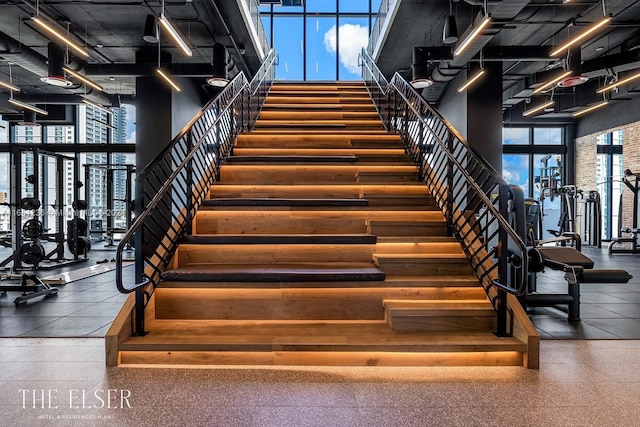 interior space featuring a wealth of natural light, a towering ceiling, and expansive windows