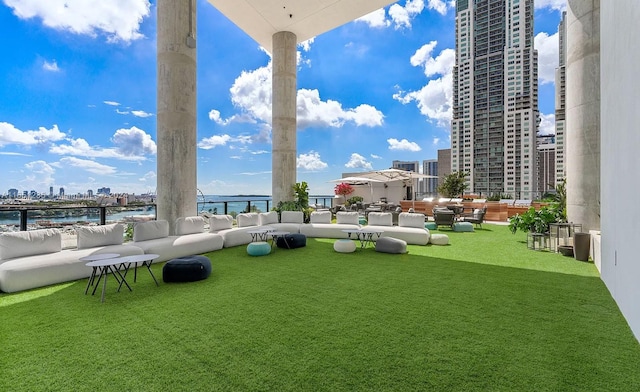 exterior space featuring a water view, a yard, and outdoor lounge area