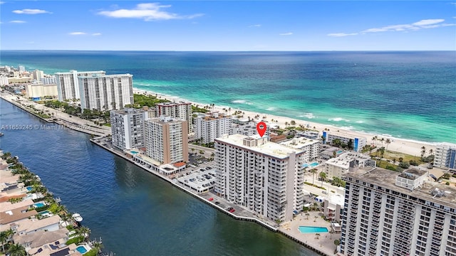 bird's eye view featuring a view of the beach and a water view