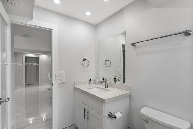 bathroom with vanity, toilet, and walk in shower