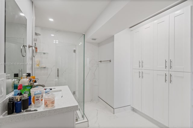 bathroom featuring vanity and a shower with shower door