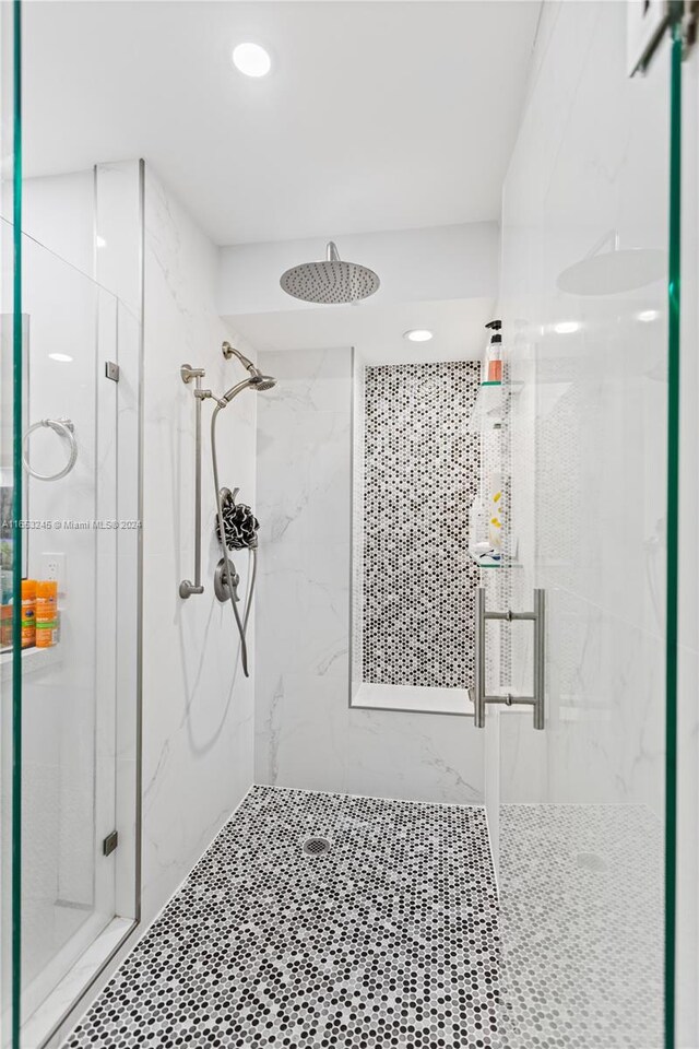 bathroom featuring a shower with shower door