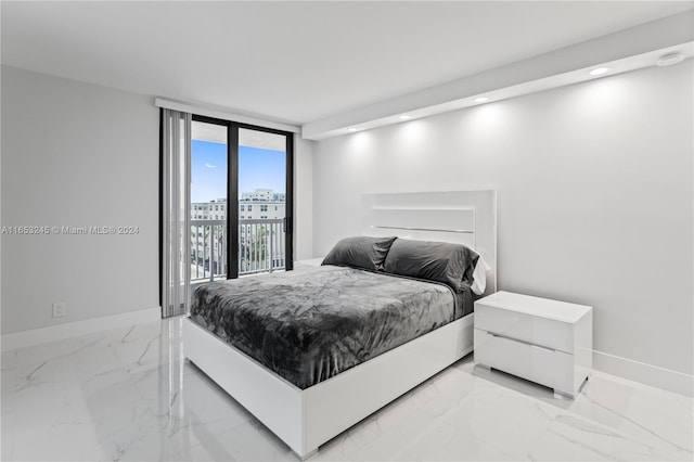 bedroom with floor to ceiling windows and access to exterior