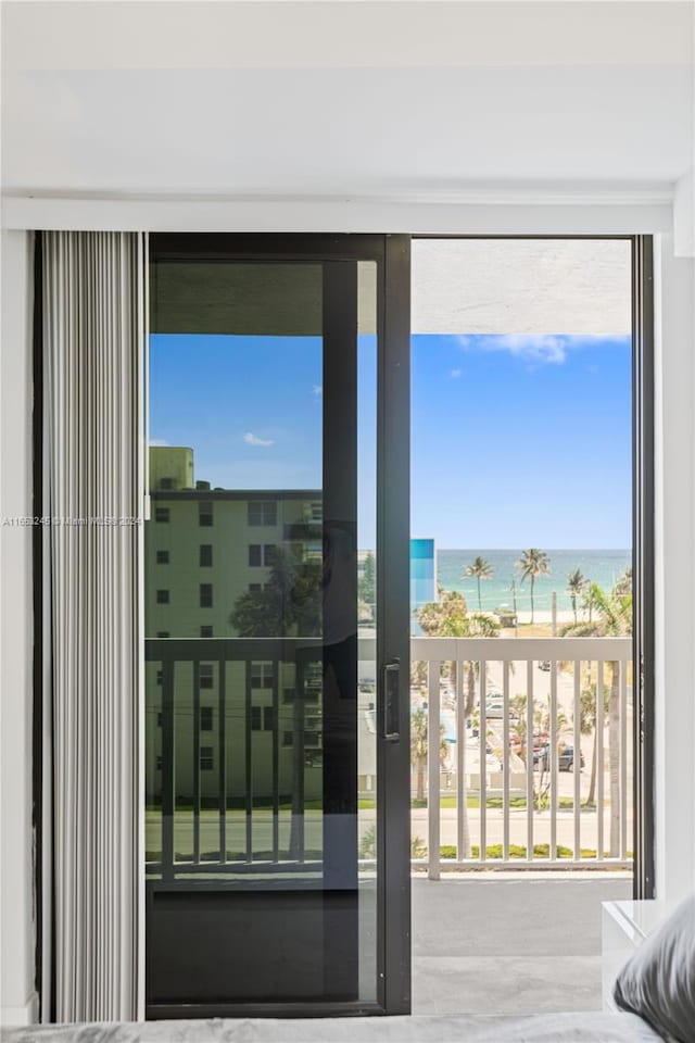 entryway with a beach view and a water view