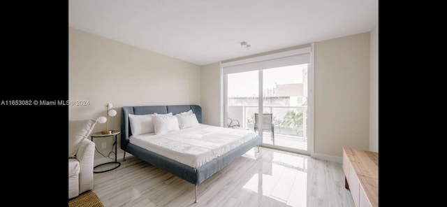 bedroom featuring access to outside and light hardwood / wood-style flooring