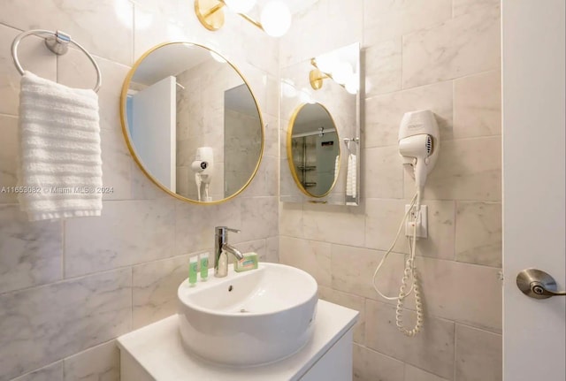 bathroom with tile walls and vanity