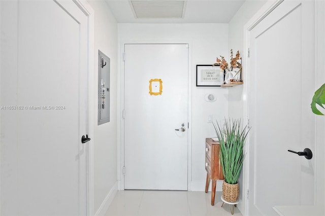 doorway to outside featuring electric panel and light tile patterned flooring