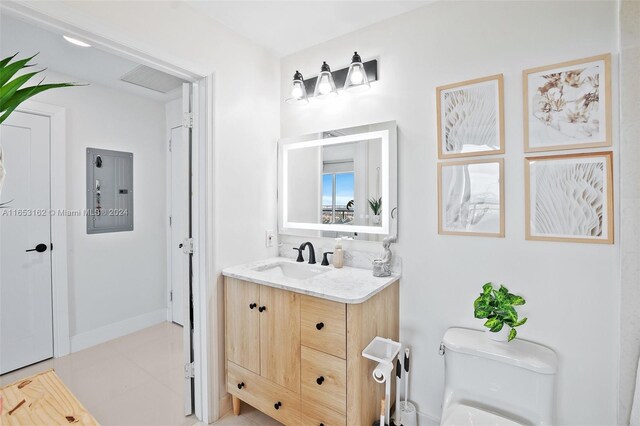 bathroom with vanity, toilet, tile patterned floors, and electric panel