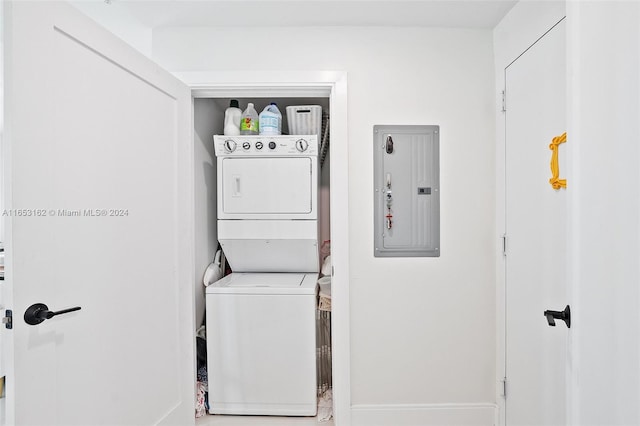 laundry room with stacked washer / dryer and electric panel