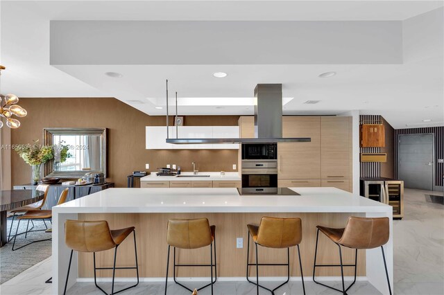 kitchen with a center island, an inviting chandelier, sink, stainless steel oven, and a kitchen bar