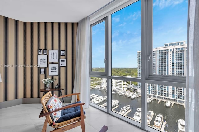 interior space featuring a water view and expansive windows