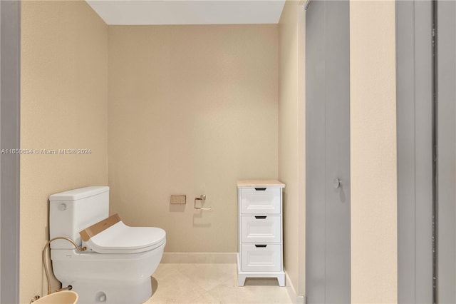 bathroom featuring toilet and tile patterned flooring