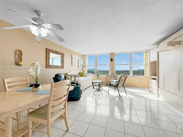 dining space with ceiling fan and light tile patterned flooring