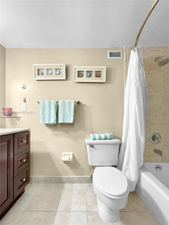 full bathroom featuring vanity, toilet, tile patterned flooring, and shower / bath combo with shower curtain