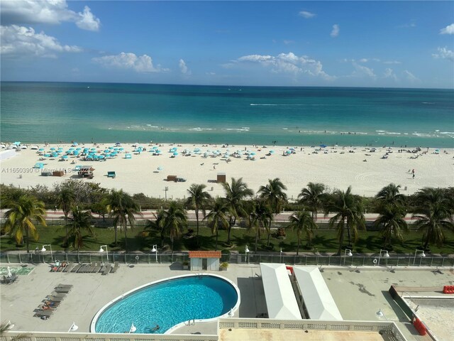 exterior space featuring a beach view and a water view