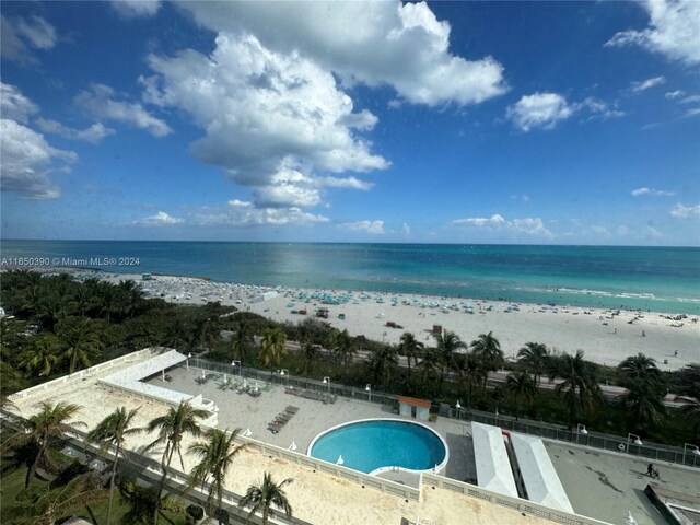 exterior space featuring a water view and a beach view