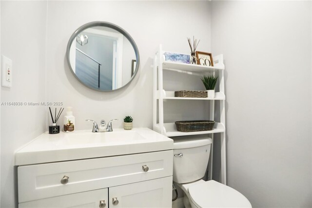 bathroom featuring toilet and vanity