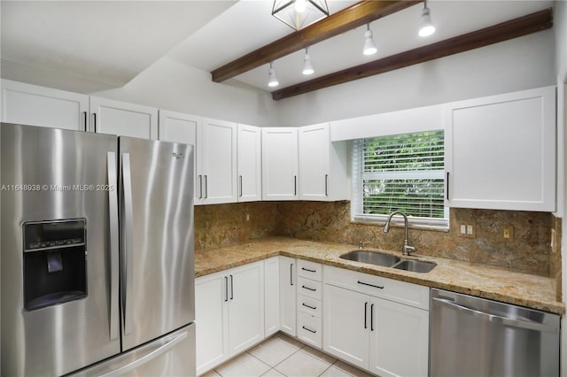 kitchen with appliances with stainless steel finishes, white cabinets, and a sink