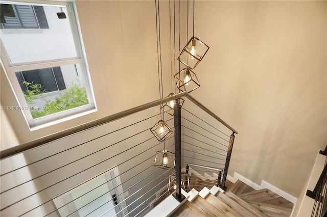 staircase featuring baseboards and wood finished floors