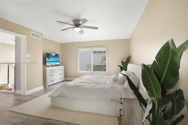 bedroom with visible vents, ceiling fan, baseboards, and wood finished floors