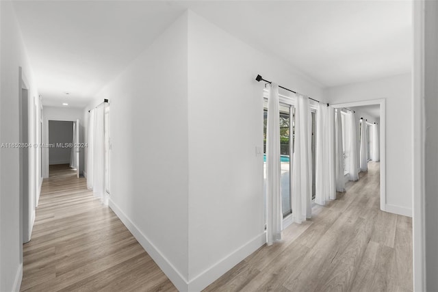 hallway with light hardwood / wood-style flooring