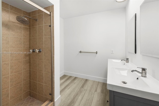 bathroom with vanity, wood-type flooring, and an enclosed shower