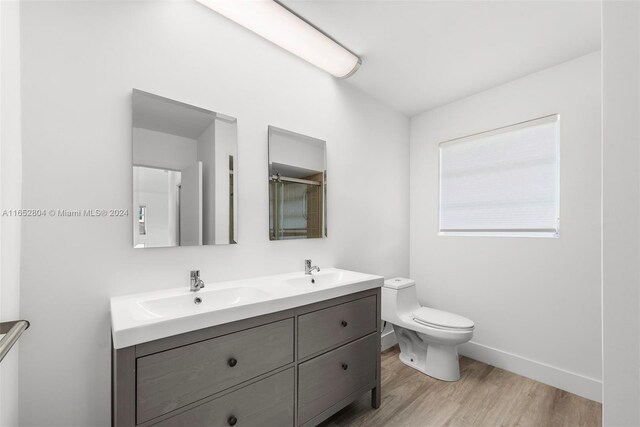 bathroom featuring vanity, toilet, and hardwood / wood-style floors